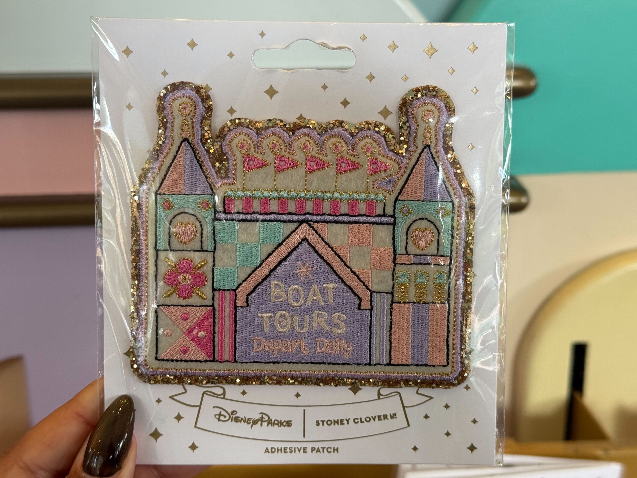a patch inspired by it's a small world with text saying boat tours depart daily