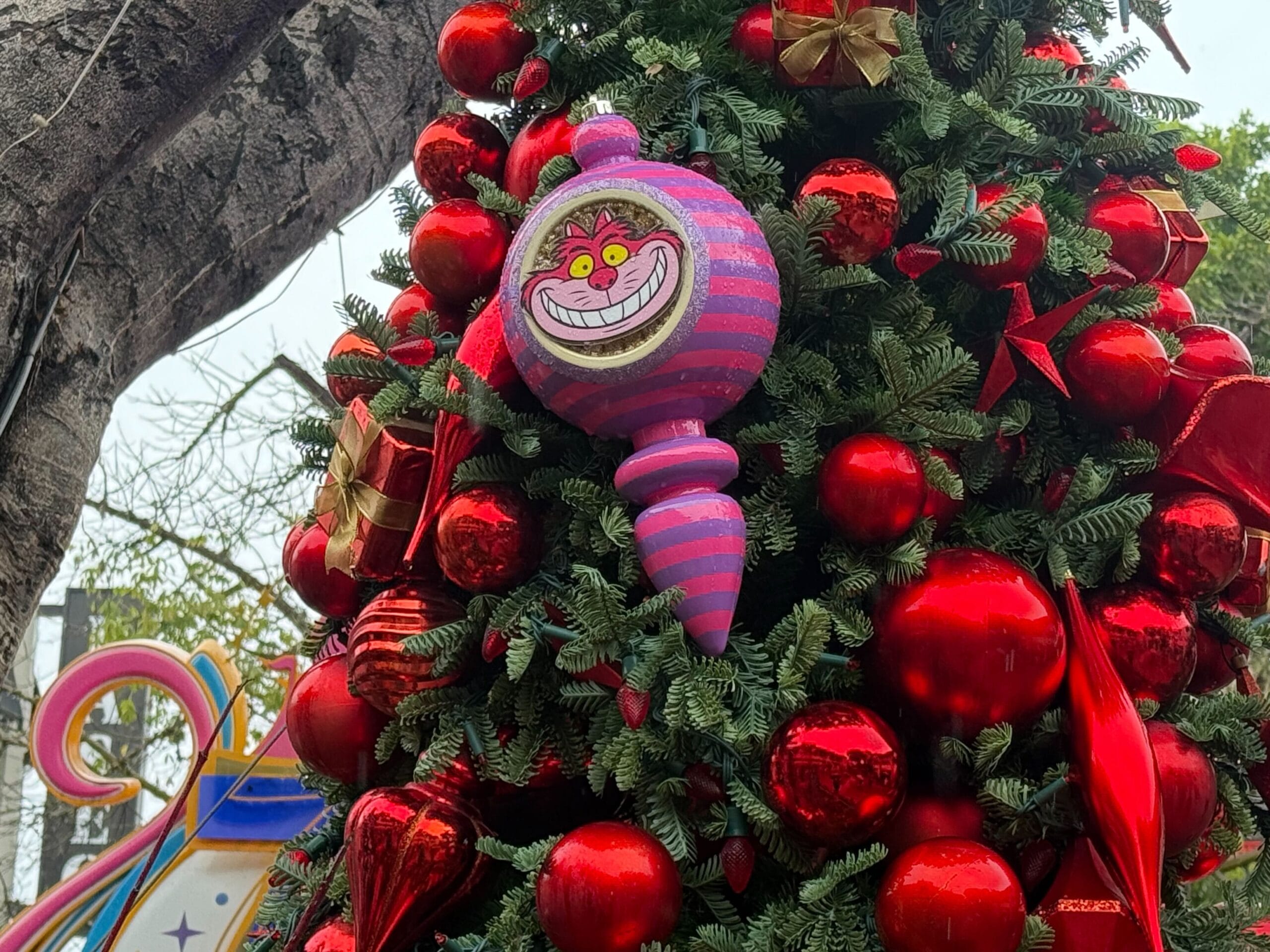 The red tree has a Cheshire Cat ornament.