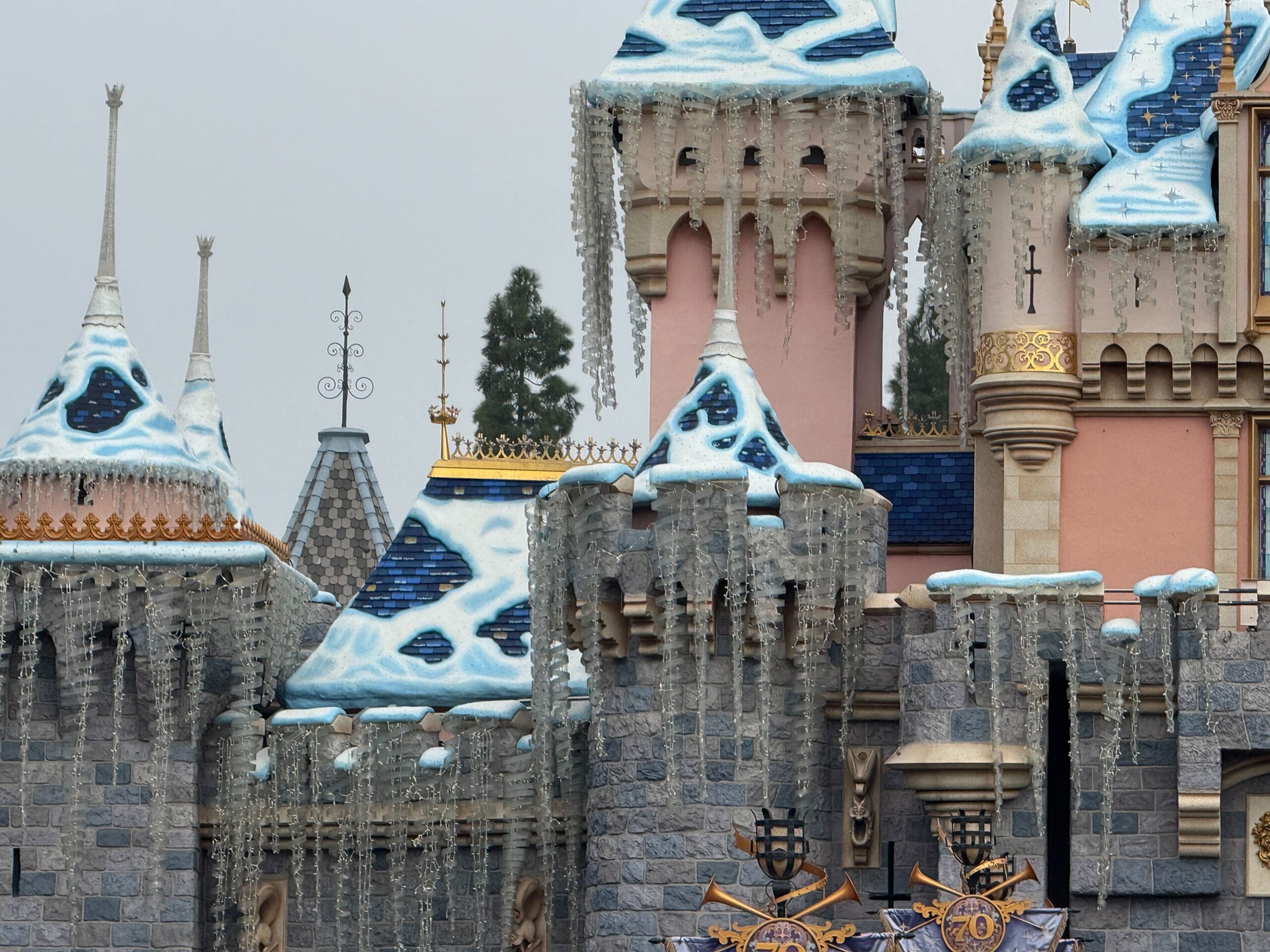 At Disneyland, snow is now fully covering Sleeping Beauty Castle completely for the 2025 holiday season.