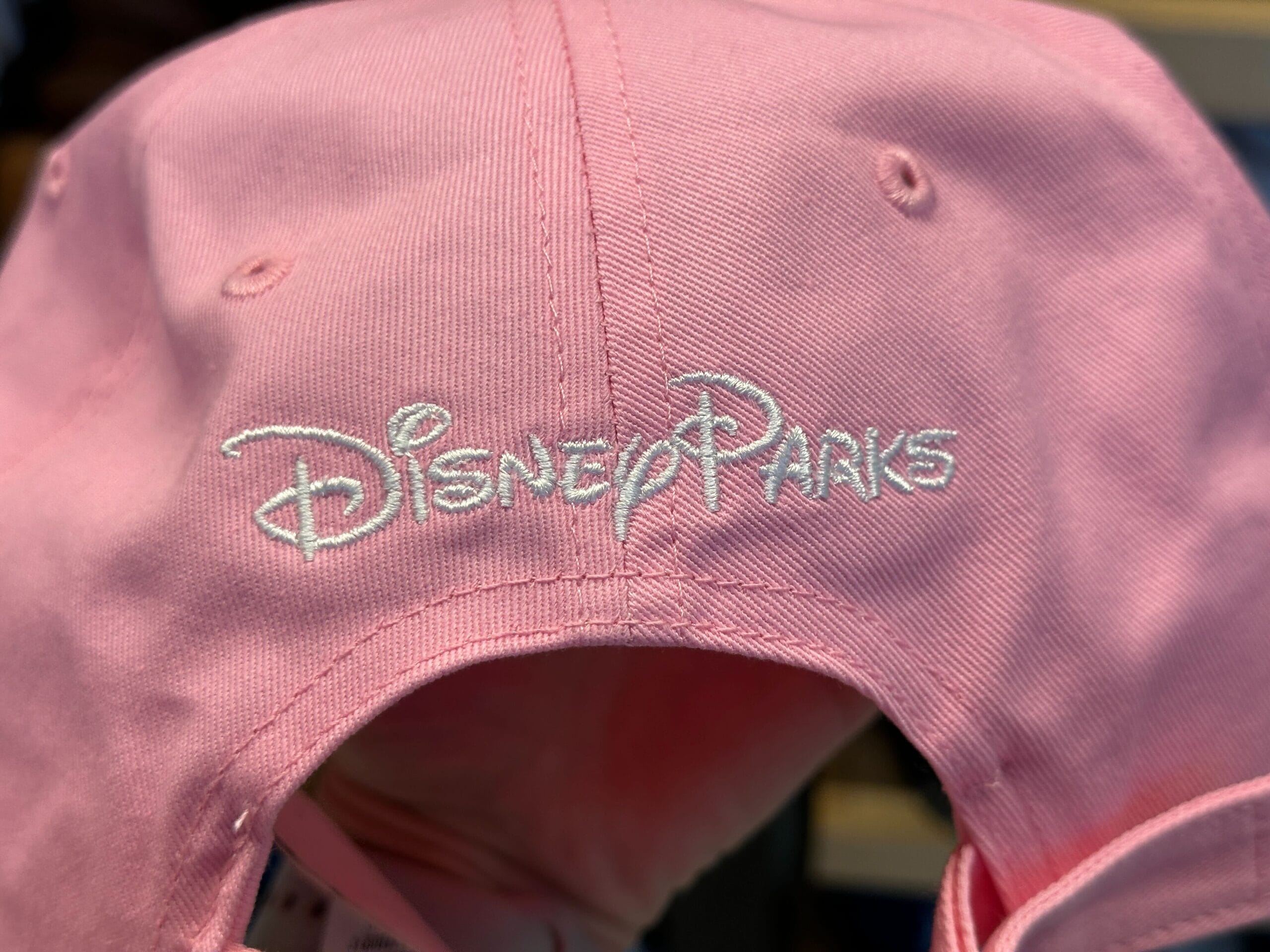 The pink baseball cap has an image of the castle inside an oval border.