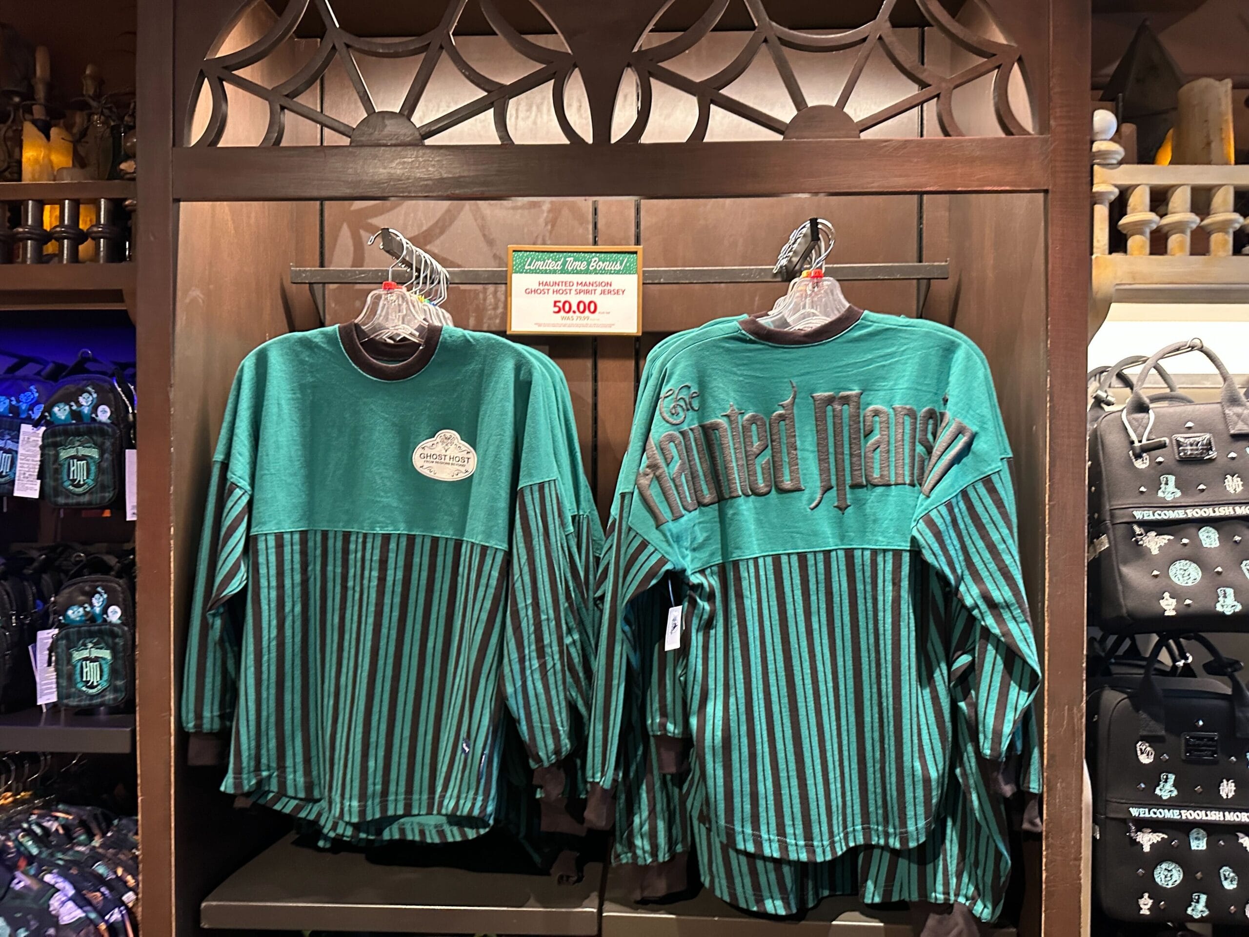 A Haunted Mansion Spirit Jersey is now available for $50, discounted from $79.99. It has a "Ghost Host" Cast Member name tag on the front.