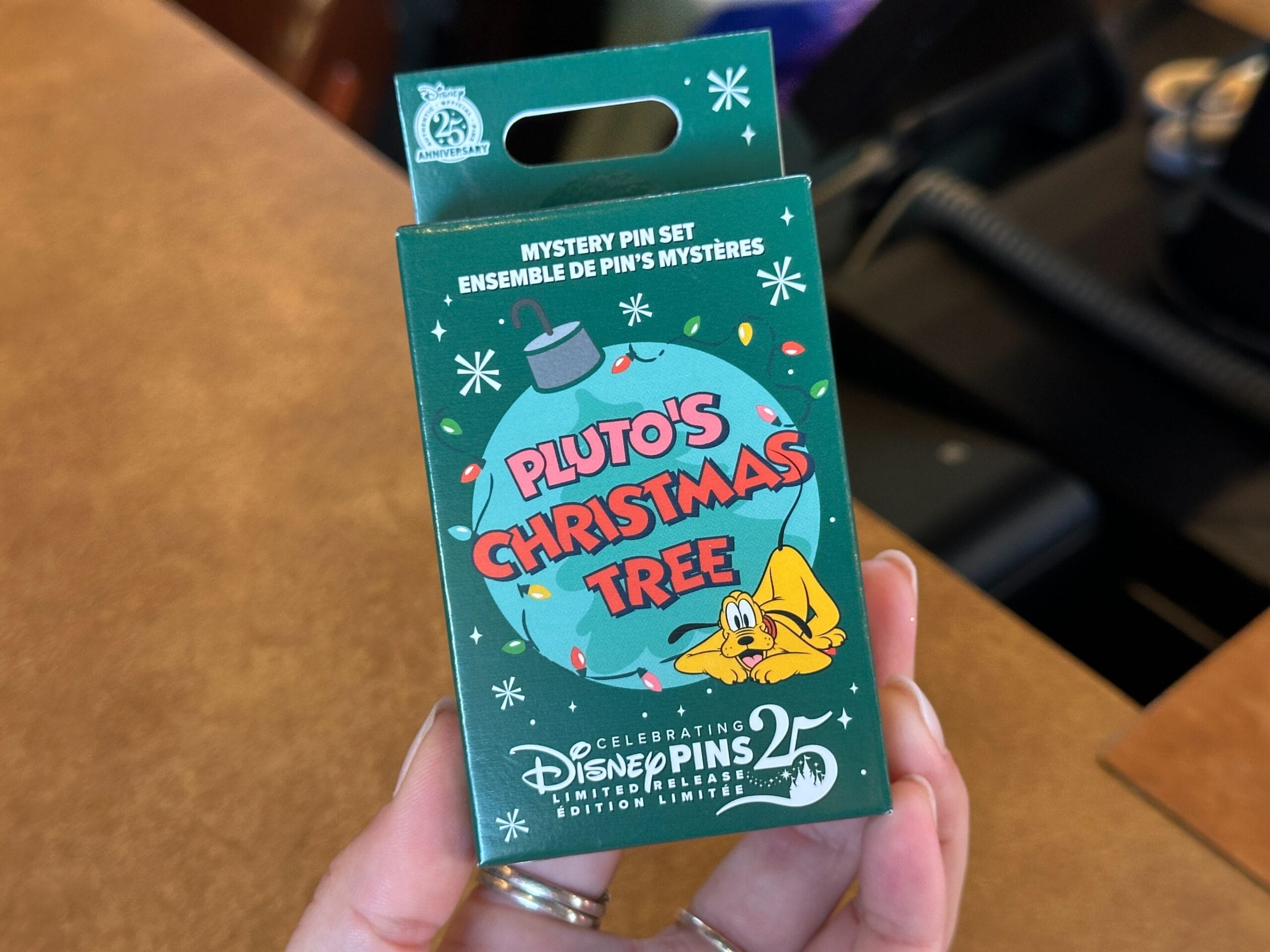 Disney World Pin Tuesday: New Pin Trading 25th Anniversary Pins, Pluto's Christmas Tree Mystery Set, and More