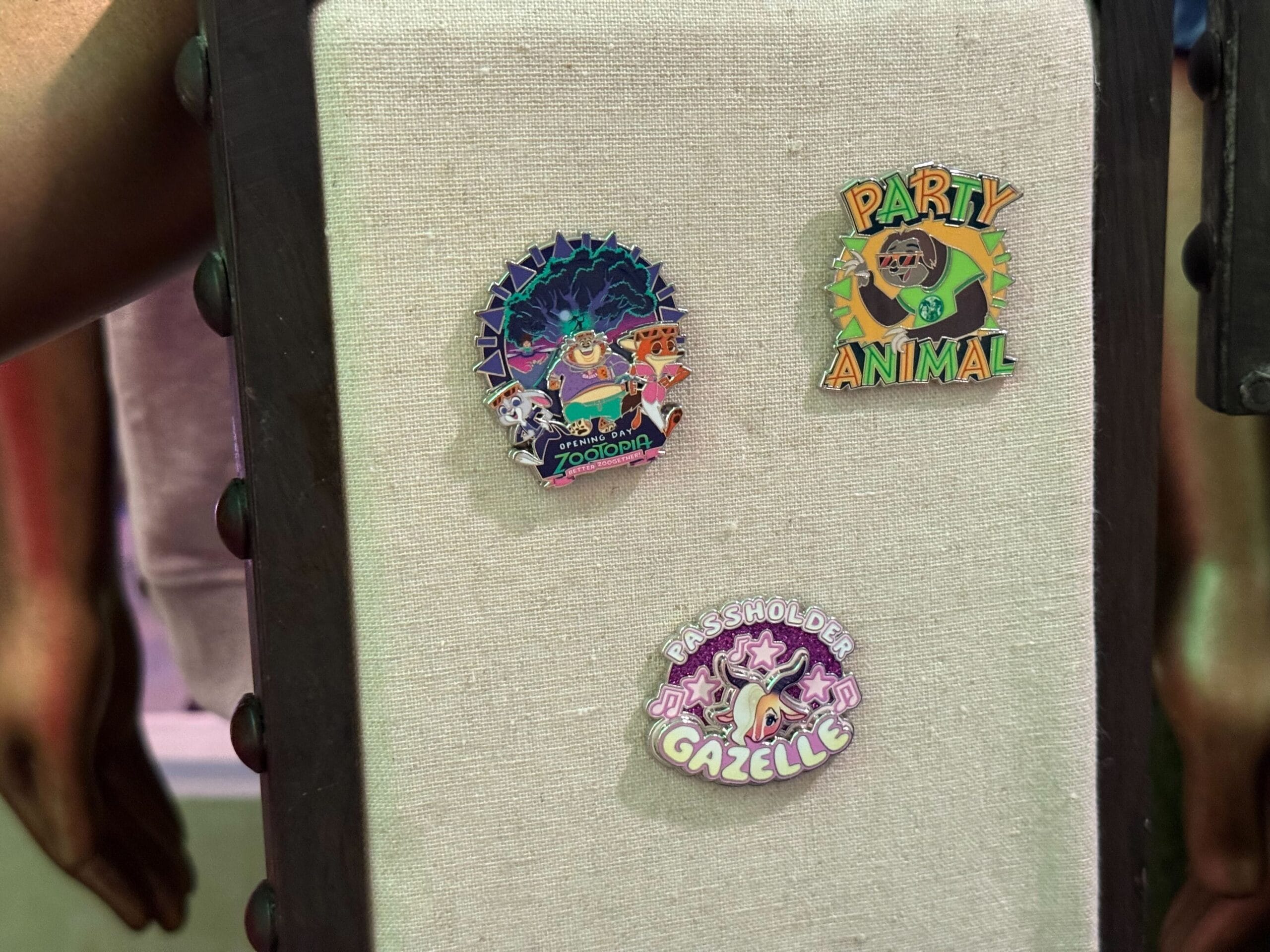 Three vibrant Disney Zootopia pins, including "Party Animal" and "Passholder Gazelle,"