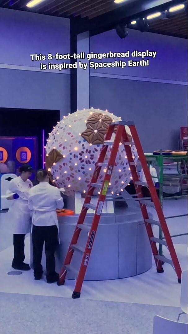 The video shows the team of pastry chefs assembling the display by attaching gingerbread panels to a lighted spherical base.