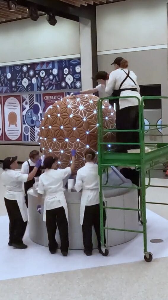 After all the gingerbread is in place, they go back and fill in all the cracks with icing.