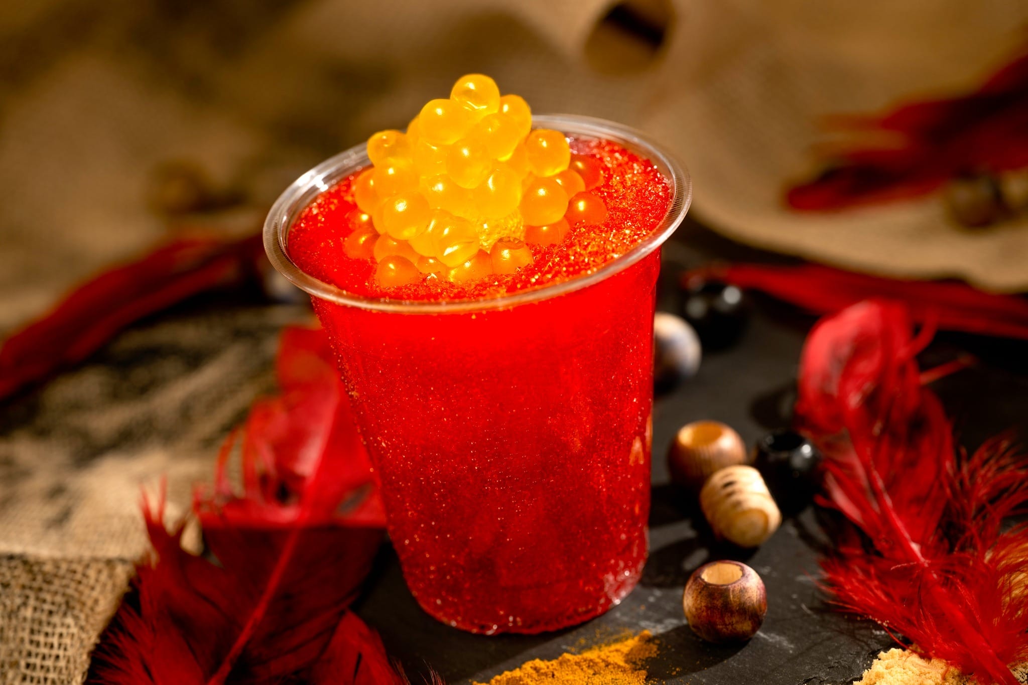 Nightwraith Blaze: blood orange, lychee, and wildberry slushy topped with a glow cube and passion fruit juice-filled pearls (also available with a float of Tito's Handmade Vodka).
