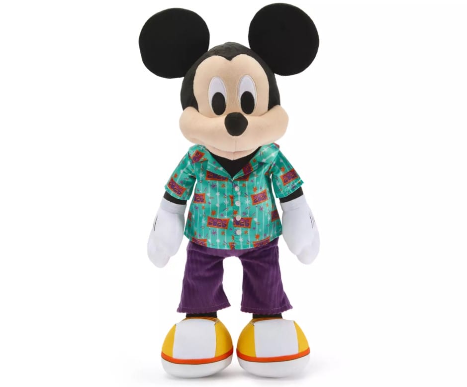 Mickey wears a satin tourist shirt with 2026 logos and a pixie dust pattern along with corduroy pants and canvas sneakers to complete the look.