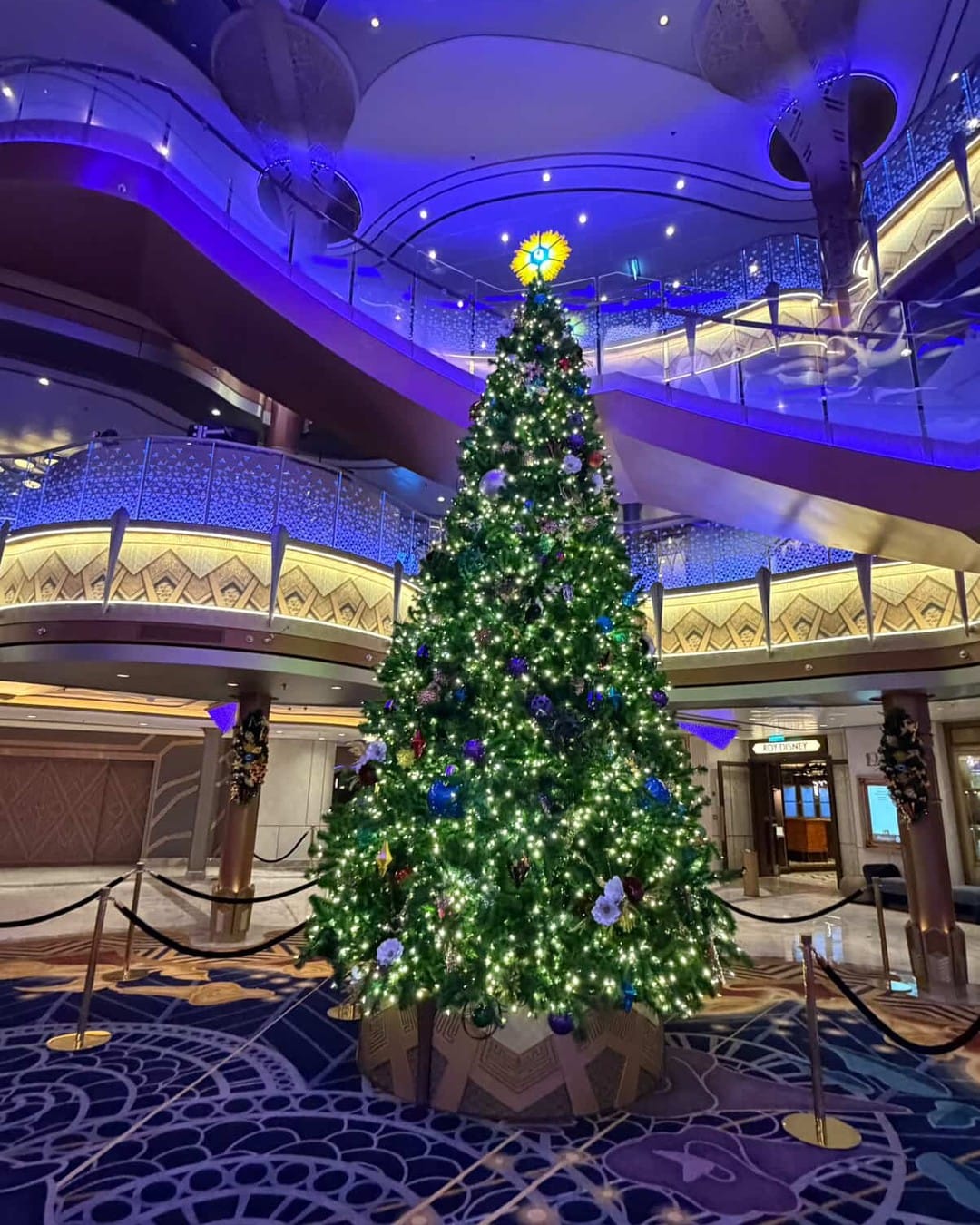 Disney Cruise Line shared photos of the Disney Destiny's unique Christmas tree lighting up the new ship's Grand Hall.