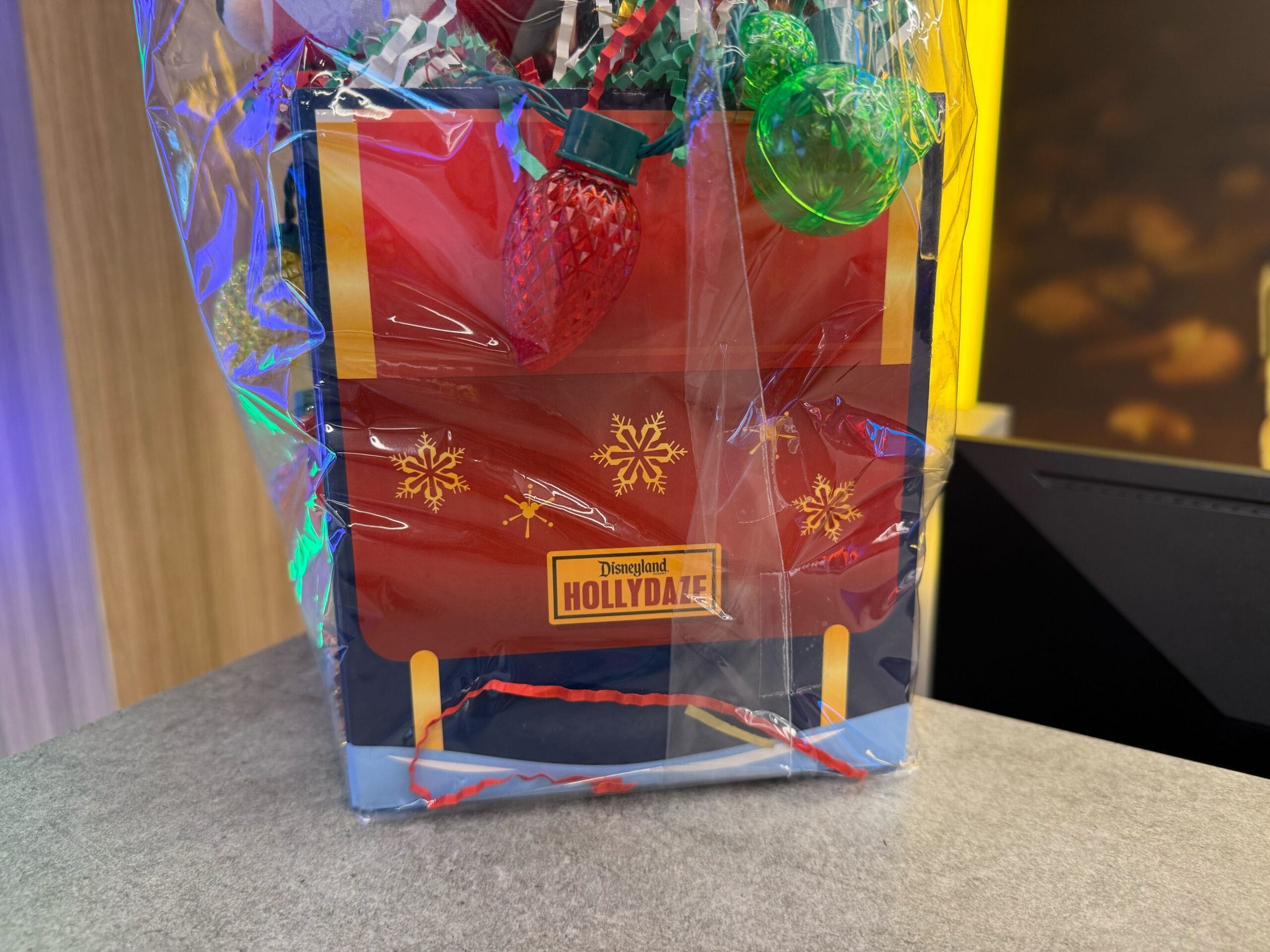 Disneyland Resort's Pixar Place Hotel is offering a special holiday gift basket this month that includes Christmas merchandise and treats.