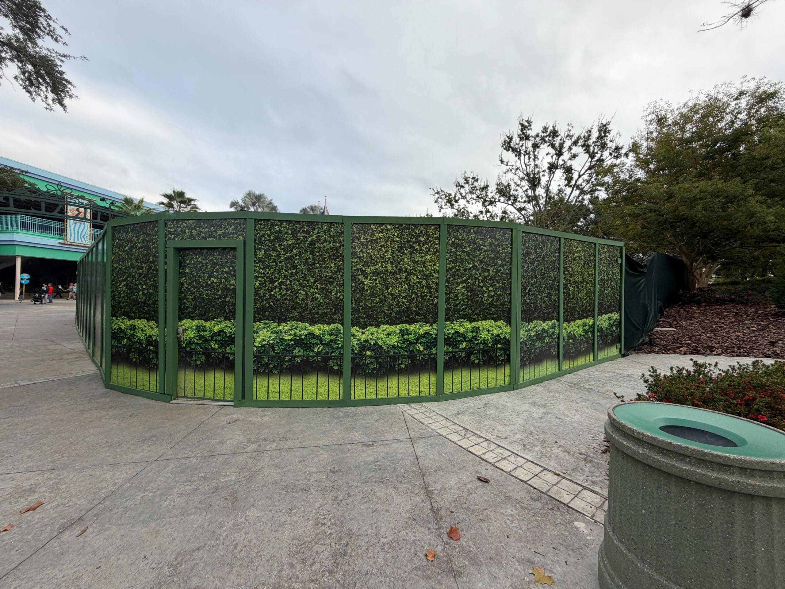 A green framework is visible above construction walls at Universal Studios Florida for a new snack kiosk.