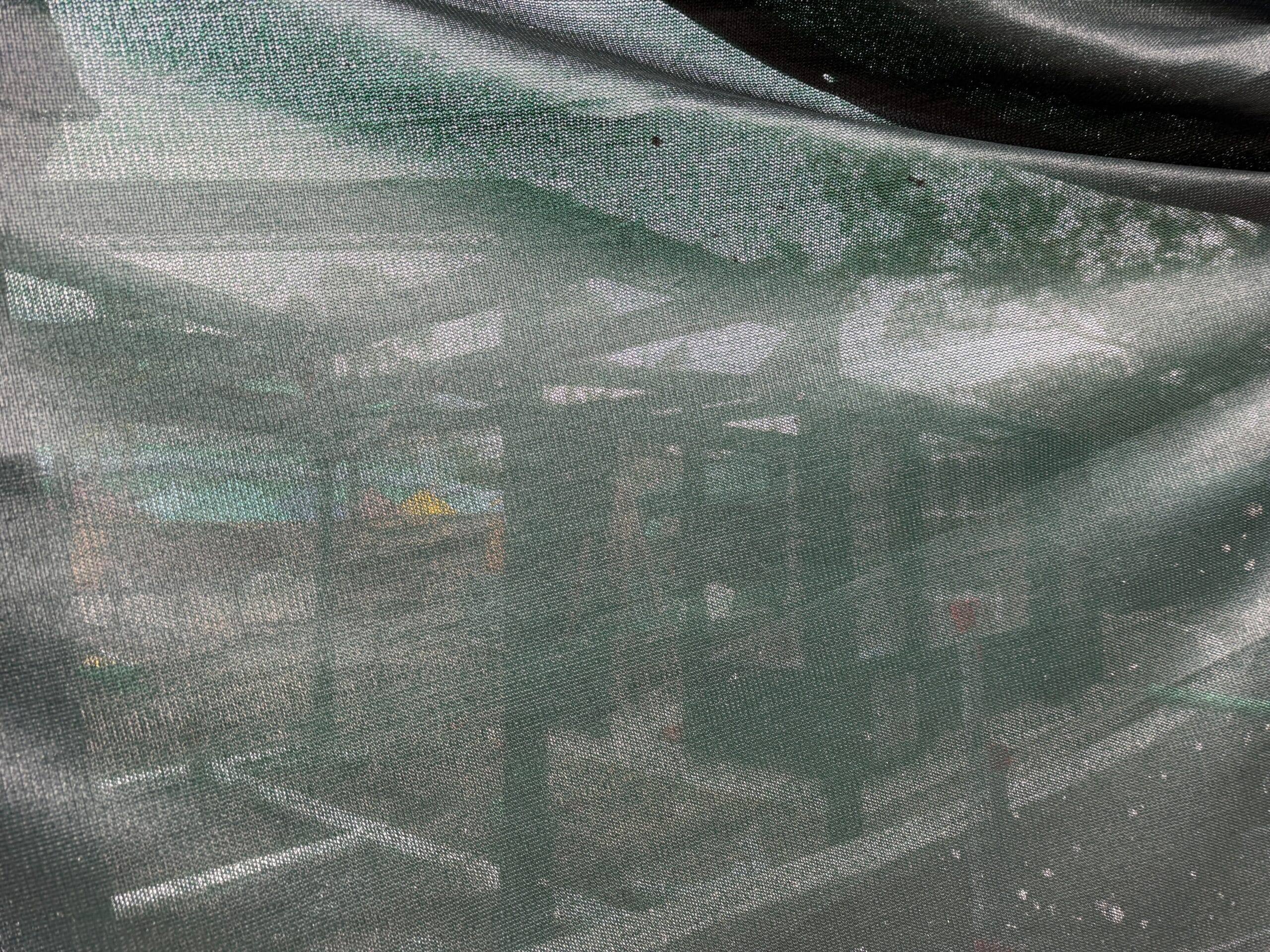 A green framework is visible above construction walls at Universal Studios Florida for a new snack kiosk.