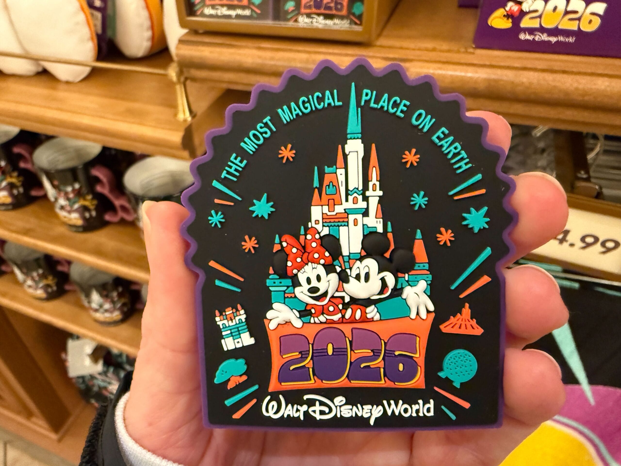 This black silicone magnet features Mickey and Minnie in front of a teal, orange, and white version of Cinderella Castle. "The Most Magical Place on Earth" is across the top and the year is in front of the mice.