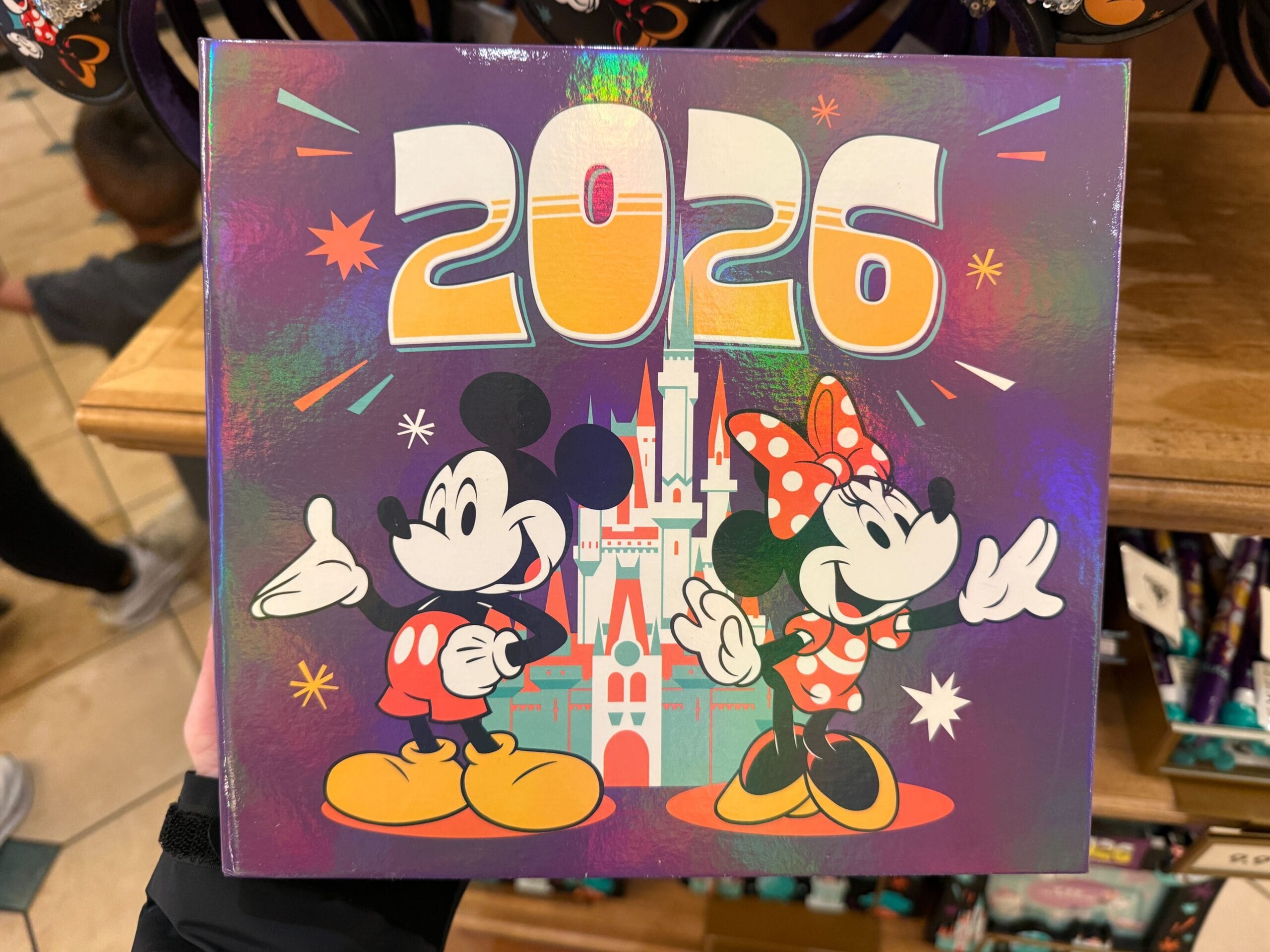 This large album is a shiny purple. Mickey, Minnie, Cinderella Castle, and "2026" are on the front.