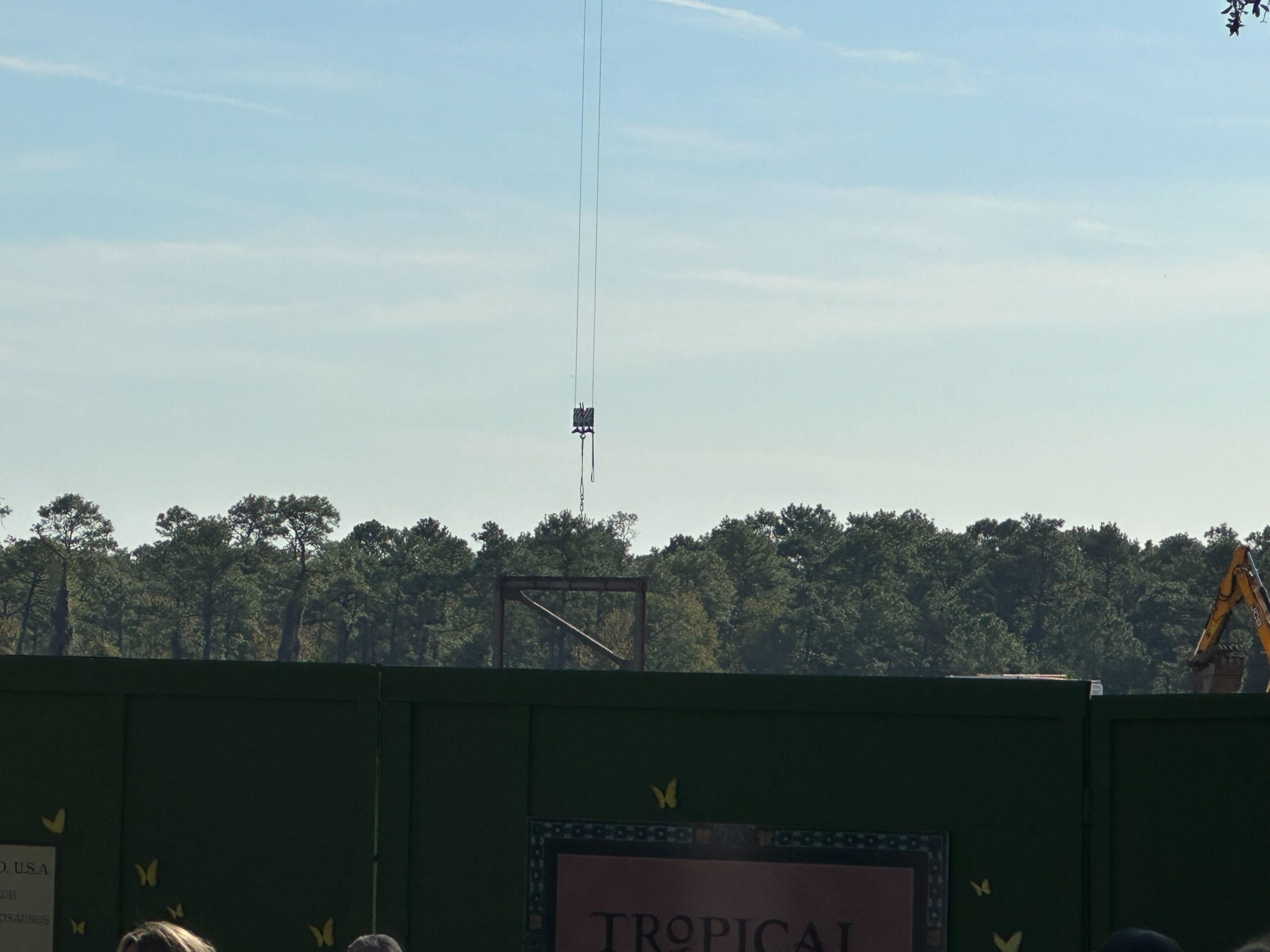 A vertical structure has risen into view behind construction walls in DinoLand U.S.A.