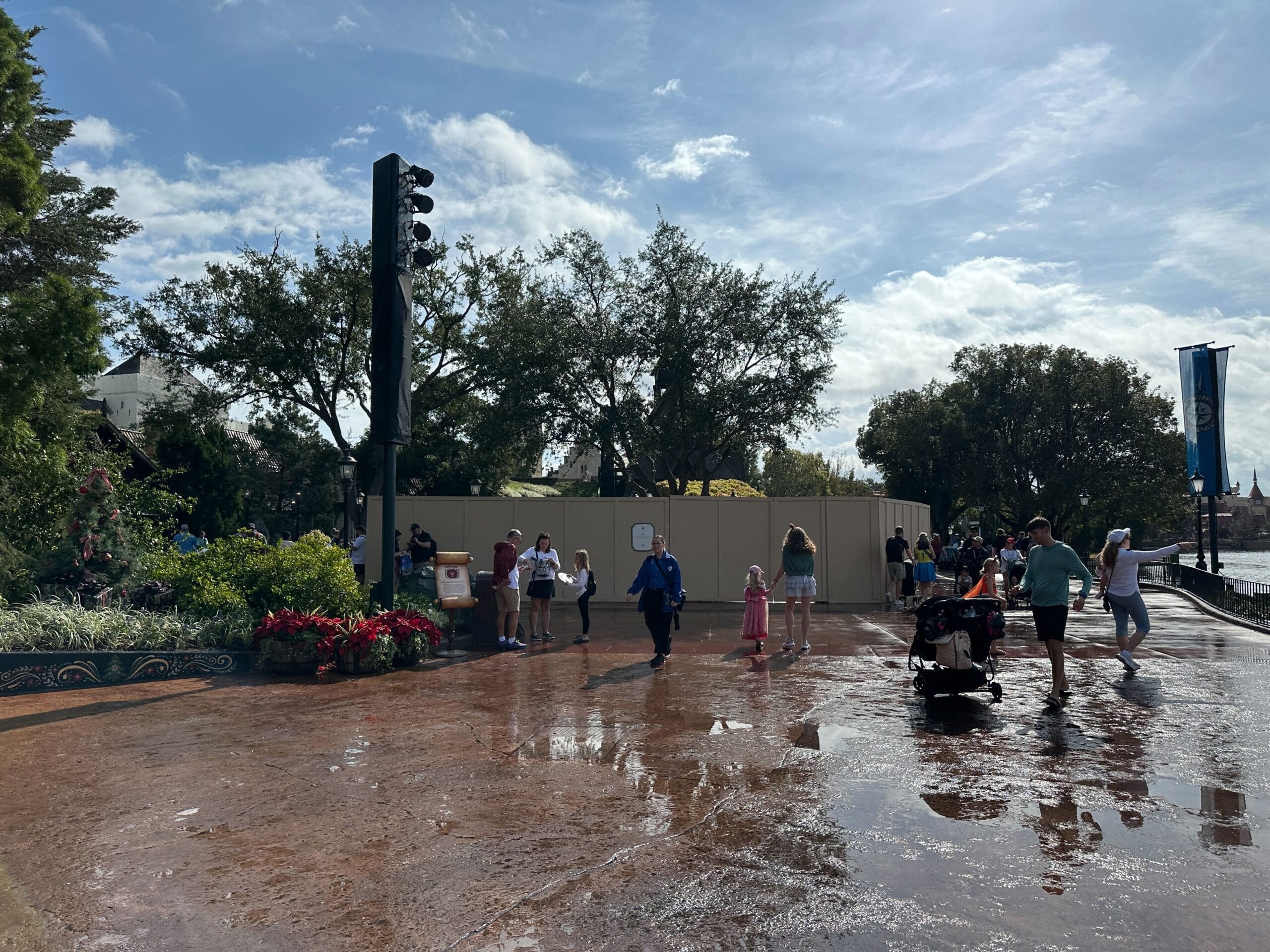Construction walls take up a large swath of walkway at the Norway pavilion of EPCOT, surrounding the site of a drink cart.