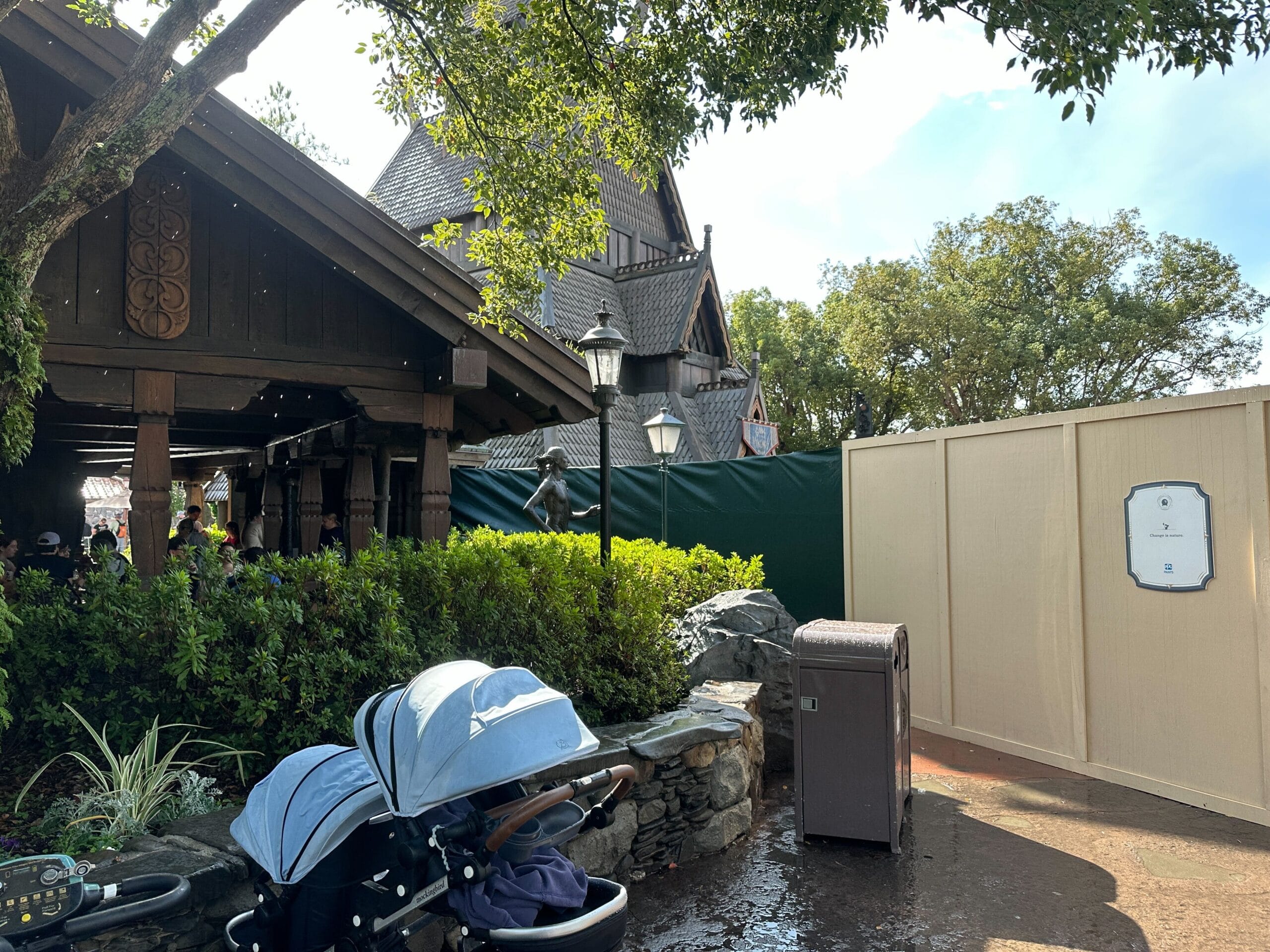 Construction walls take up a large swath of walkway at the Norway pavilion of EPCOT, surrounding the site of a drink cart.