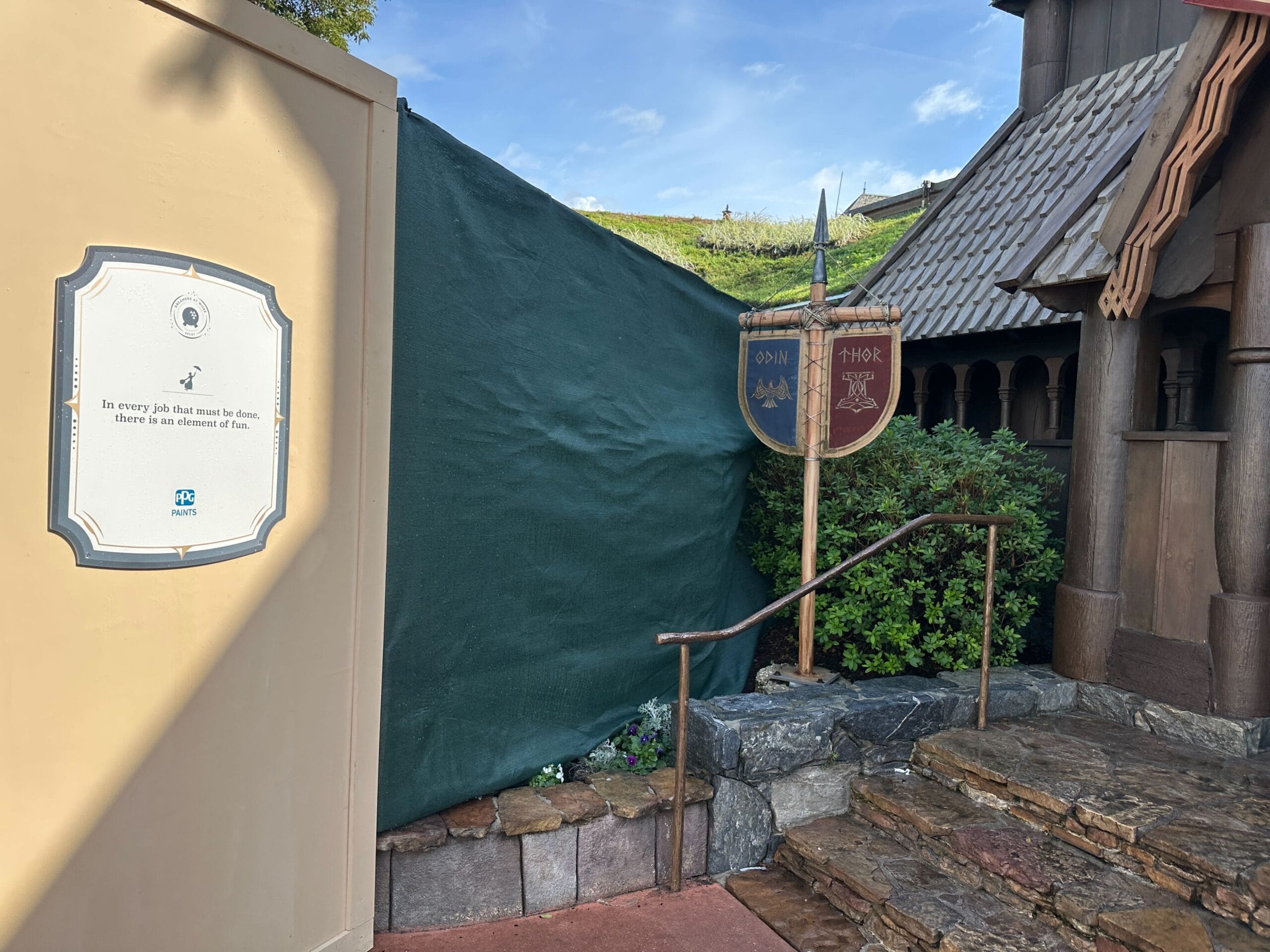 Construction walls take up a large swath of walkway at the Norway pavilion of EPCOT, surrounding the site of a drink cart.