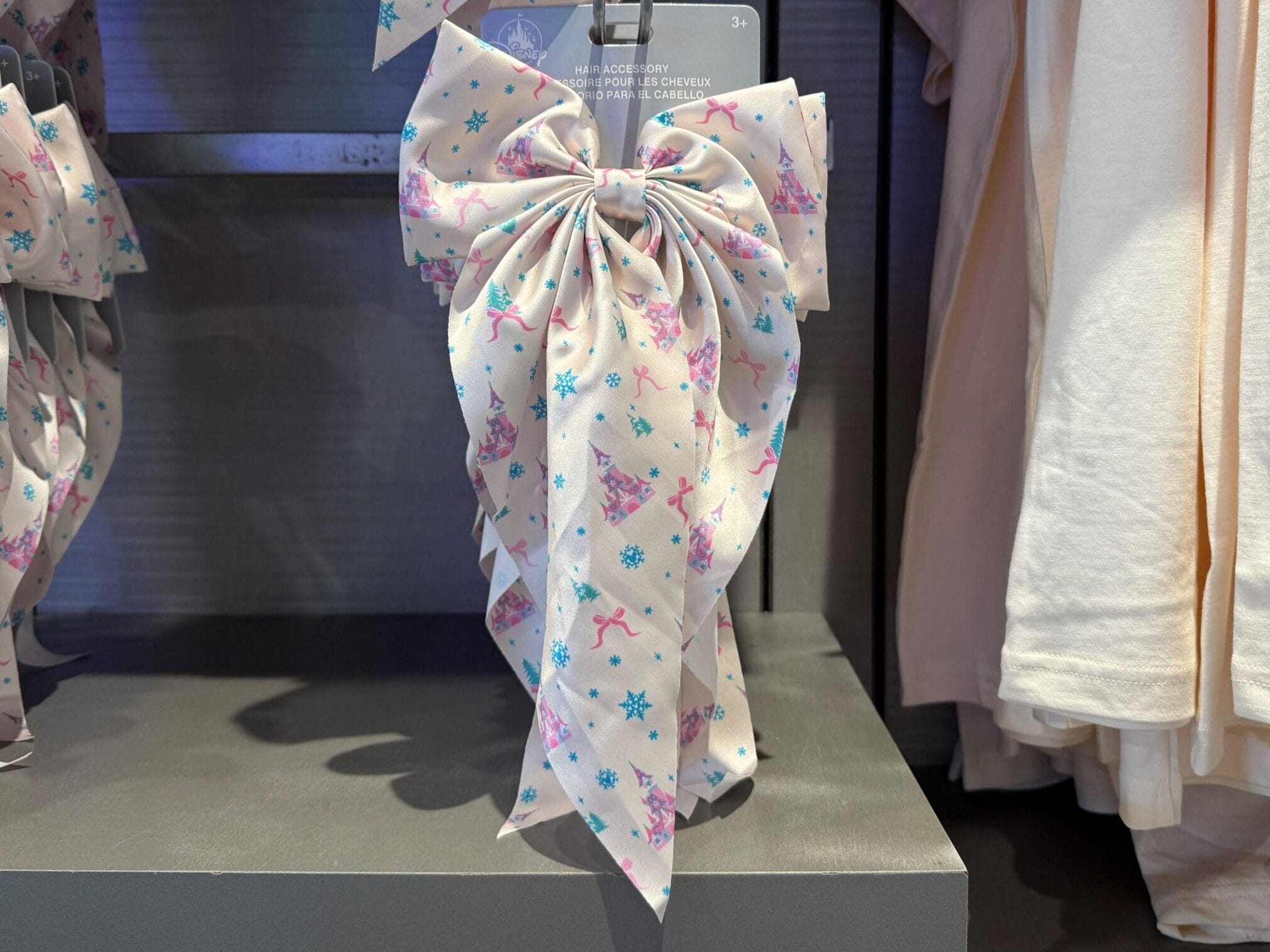 This hair accessory is white and features little, pink castles along with pink bows.