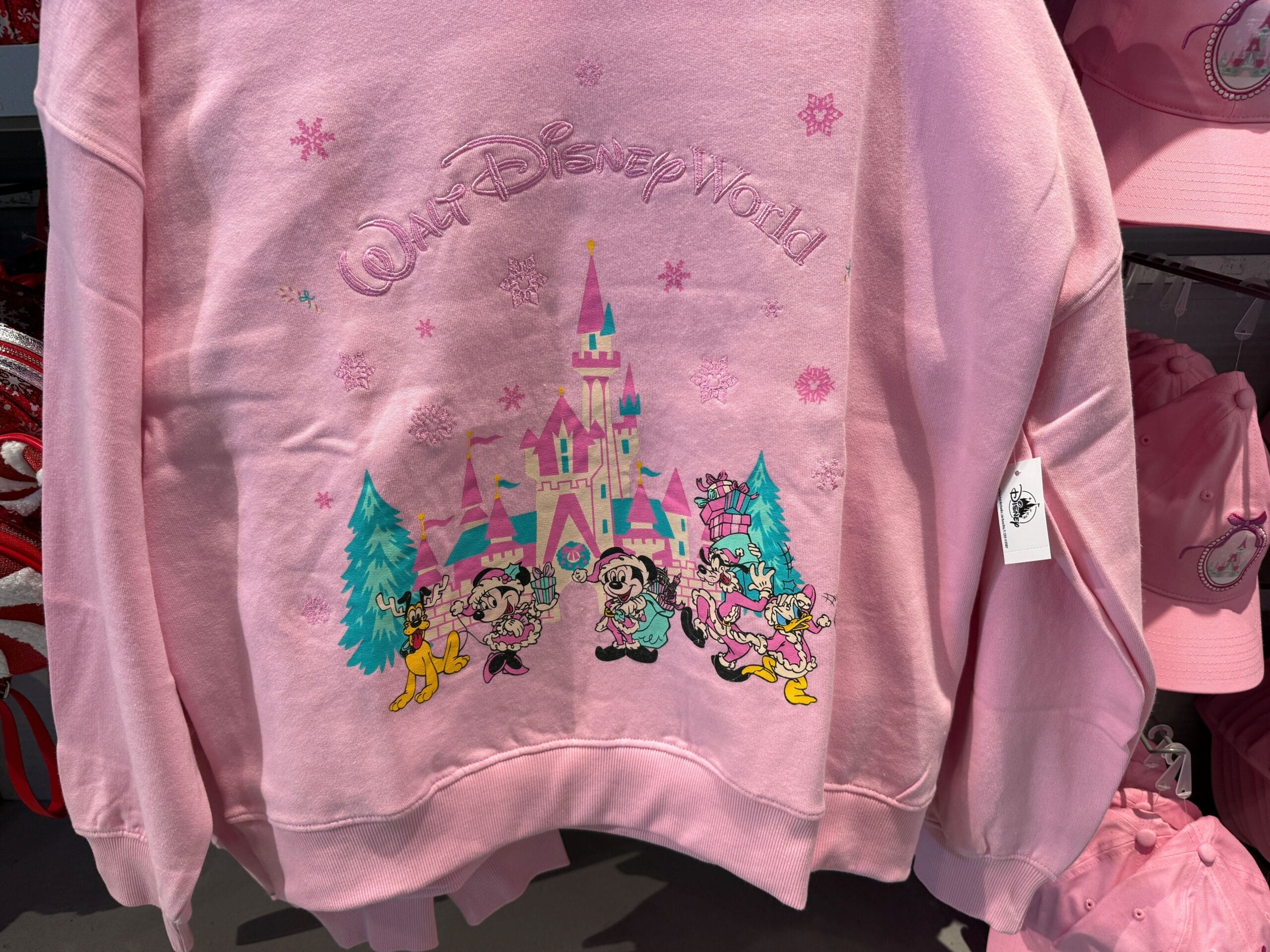 Mickey and Friends are wearing their pastel pink holiday best on this bright pink crewneck sweatshirt.