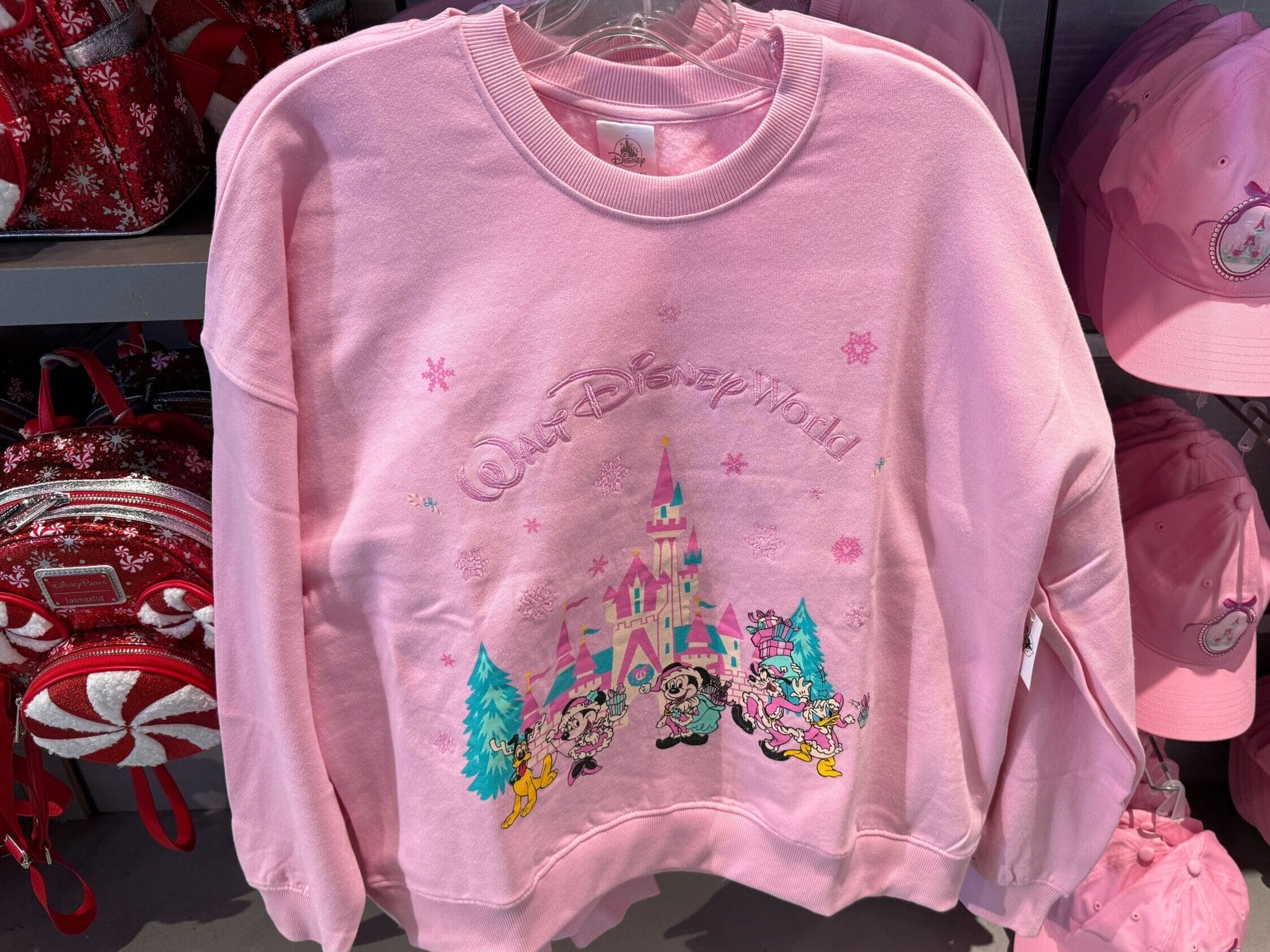 Mickey and Friends are wearing their pastel pink holiday best on this bright pink crewneck sweatshirt.